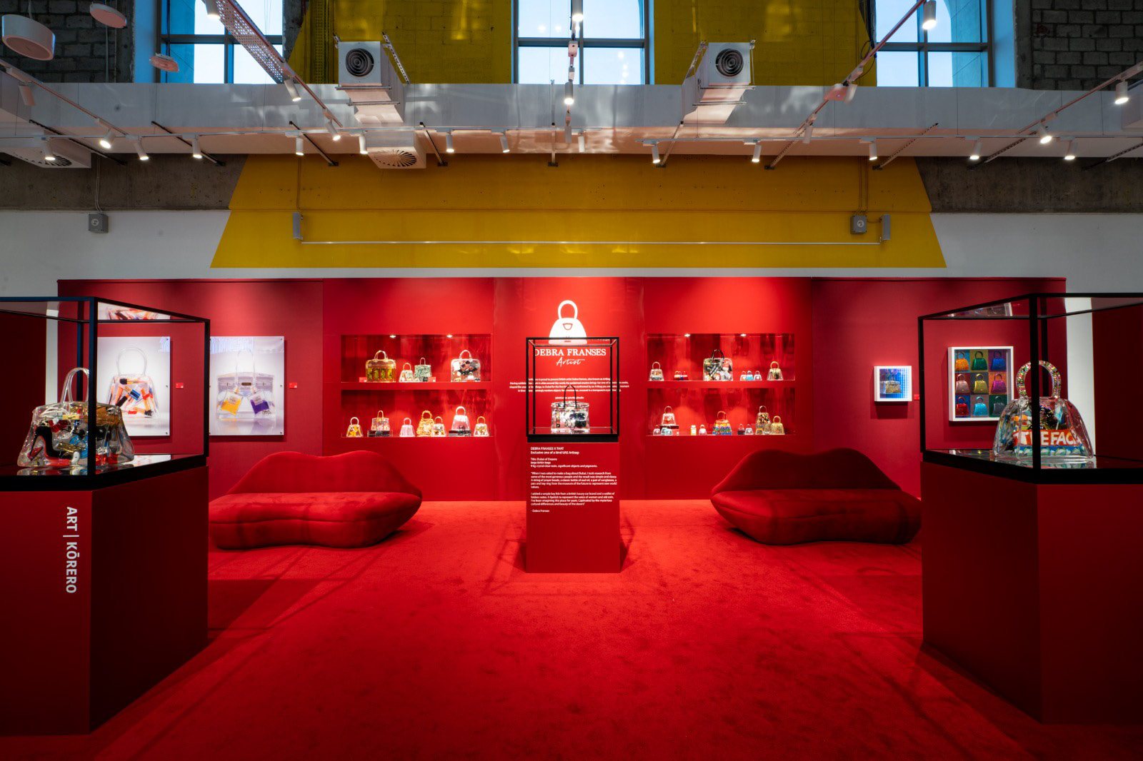 Art | Korero exhibition environment in saturated red with display niches and vitrines